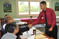 Spc. Joshua Walton, a soldier assigned to the Warrior Transition Battalion-Europe, greets interview panel members during his mock interview Sept 18, at Baumholder's Rolling Hills Golf Club. (Photo Credit: Gino Mattorano)