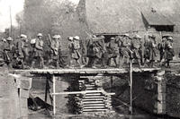 New York National Guard soldiers of the 27th Infantry Division cross a bridge over the LeSelle River on their way to St. Souplet, France during the Hindenburg Line campaign in the fall of 1918. The bridge was built by the Soldiers of the 102nd Engineer Battalion. (New York State Military Museum photo)