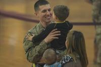 A soldier, assigned to 2nd Infantry Brigade Combat Team, 4th Infantry Division, returning from an overseas deployment, holds his son following a homecoming ceremony Oct. 31, 2018, held at the William Bill Reed Special Events Center at Fort Carson, Colorado. A different type of veteran is emerging from the post-9/11 wars that will force veterans organizations to adapt. (U.S. Army photo by Spc. Robert Vicens)