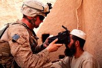 Lance Cpl. Andrew Derr of the 2nd Marine Regiment scans an Afghan man's retinas with the Biometric Enrollment and Screening Device while conducting counter-insurgency operations in Helmand province, Afghanistan. Now the Marines want a sensor to monitor the mental and physical well-being of their own troops.(US Marine Corps photo/Alejandro Pena)
