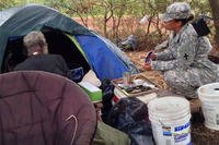 A soldier talks with a homeless veteran ahead of the annual Veterans Stand-Down in Honolulu, Aug. 5, 2015. (US Army)