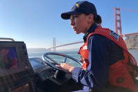 Petty Officer 1st Class Krystyna Duffy, a boatswain's mate assigned to Coast Guard Station Golden Gate in San Francisco, drives a 47-foot Motor Lifeboat near the Golden Gate Bridge, Feb. 8, 2018. (U.S. Coast Guard photo)