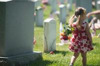 A child carries roses through Section 60 of Arlington National Cemetery on Memorial Day, May 25, 2015. (U.S. Army/Rachel Larue)