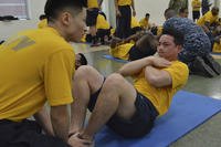 A Reserve sailor performs curl-ups during the physical readiness test in the drill hall at Navy Operational Support Center (NOSC) Los Angeles. (Pyoung K. Yi/Navy)