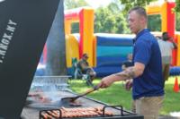 A soldier grills hamburgers