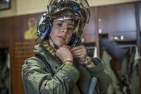 Capt. Anneliese Satz puts on her flight helmet prior to a training flight aboard Marine Corps Air Station Beaufort, South Carolina, on March 11, 2019. Satz graduated the F-35B Lighting II Pilot Training Program in June and will be assigned to Marine Fighter Attack Squadron 121 in Iwakuni, Japan. (U.S. Marine Corps photo by Sgt. Ashley Phillips)