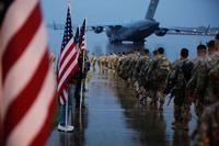 Paratroopers prepare equipment and load aircraft.