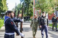 U.S. Navy Vice Adm. Lisa Franchetti walking in front of Italian sailors.