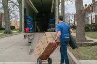 A moving contractor loads a truck with a service member's goods during the PCS peak-season at Scott Air Force Base,.