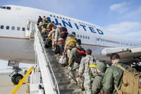 Airmen boarding airplane.