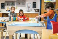 children playing with art projects