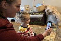 woman and child video chatting on phone