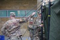 Members of the Maryland National Guard set up a tent outside at Adventist Health Care White Oak Medical Center.