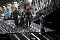 Military medical personnel transfer twin newborns Parker and Laine McFall.