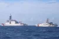 The Coast Guard Cutter James conducts relief operations alongside the Coast Guard Cutter Paul Clark.