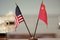 Miniature U.S. and Chinese flags on a table before a meeting at the Pentagon, Sept. 11, 2013. 