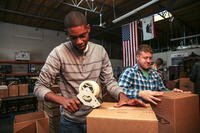 two men taping up boxes