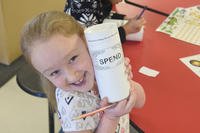 child with her &quot;spend&quot; container