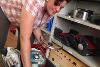 woman packing dishes into a tote