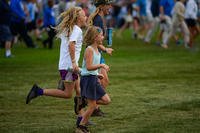 children running across a field