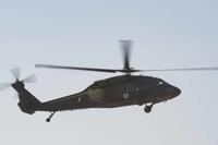 An Afghan Air Force UH-60 Black Hawk helicopter hovers over Kandahar Airfield.