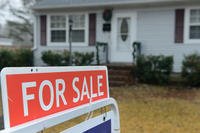 for sale sign in front of house