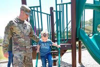 father and son playing on playground