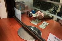 Military clerk handing money through window