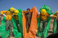 Marines conduct practical application of a practice fire shelter at Camp Pendleton. 