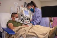 A phlebotomist draws blood  to collect convalescent COVID-19 plasma.