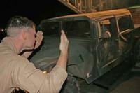 Cpl. Matt Hunter directs a Humvee into one of Marine Aerial Refueler Transport Squadron 252's KC-130Js so that it can retrieve a piece of cargo carried by the aircraft from Al Asad, Iraq, to Baghdad.