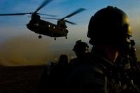 Members of an Afghan-international security force prepare to board a CH-47 Chinook.