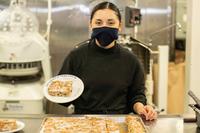 A culinary specialist shows off a dessert in Ford's aft galley