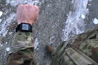 A soldier uses a fitness tracker