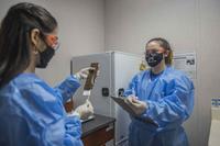 An Operation Warp Speed research pharmacy technician documents whether a patient receives a vaccine or placebo