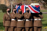 The coffin of Captain Sir Tom Moore is carried by members of the Armed Forces during his funeral.