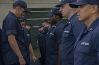 Lieutenant commander inspects Coast Guard uniforms