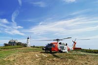 Coast Guard MH-60 Jayhawk helicopter near Wood Island Lighthouse in Saco Bay, Maine