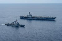 Aircraft carrier USS Theodore Roosevelt (CVN 71) and guided-missile destroyer USS Lassen (DDG 82) sail in formation through the South China Sea