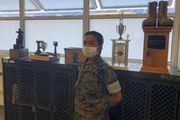 Pfc. Emily Zamudio poses with the awards earned by Lima Company.