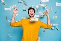 Man happily standing in a shower of currency
