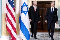 Secretary of State Antony Blinken, right, walks with Israel's Defense Minister Benny Gantz
