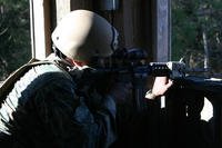 Marine fires at targets during special ops training course.