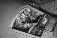 Marine Lt. Col. John Glenn reaches for controls inside a Mercury capsule in 1961.