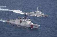 Coast Guard cutter Munro, bottom, and Japan Coat Guard patrol vessel Large Aso transit together.