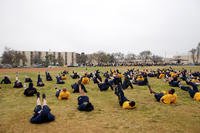 Sailors perform flutter kicks during morning workout.