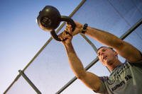 A Luke Thunderbolt performs a kettlebell swing during the Trojan Warrior Workout.