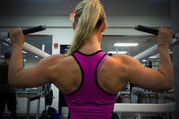 Senior airman works on lat pulldowns.