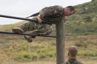 A RECON Marine navigates an obstacle course.