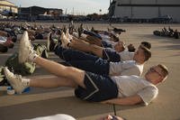 Airmen perform flutter kicks.